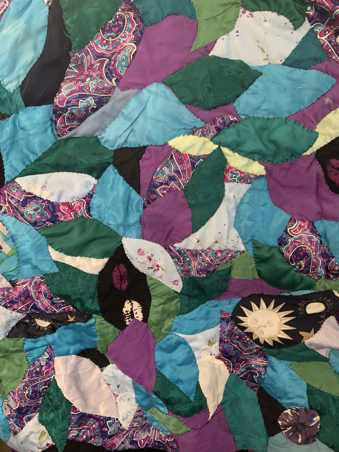 crazy quilt patchwork detail mostly in blues, purples, and greens