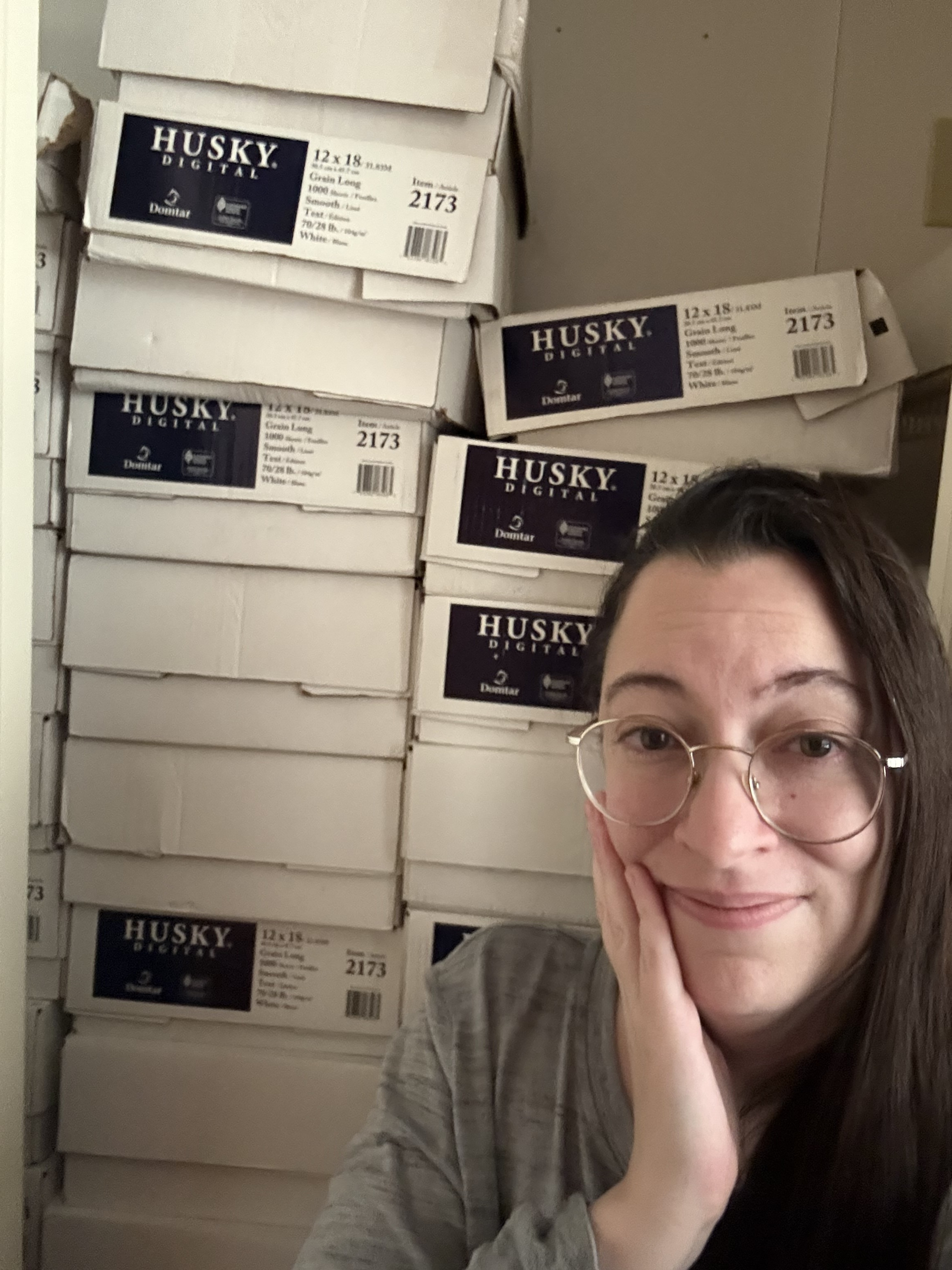 Angela in front of the full closet of books.