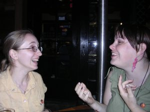 Two women, Alana and Ariel, laughing as they talk to each other