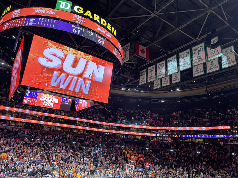 "SUN WIN" appears on the jumbotron at TD Garden in Boston, Massachusetts, on August 18, 2024, with 18 Boston Celtics championship banners hanging in the background. 