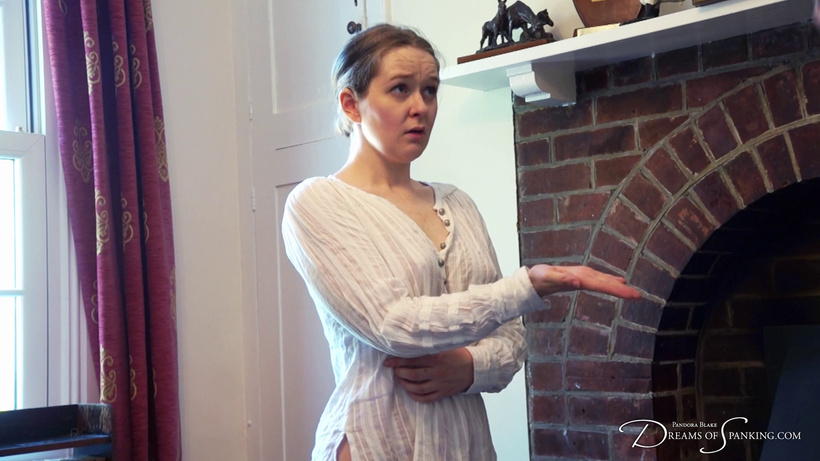 Faerie Willow stands wearing a white shift in a Victorian parlour, holding out her hand and looking up with a worried expression