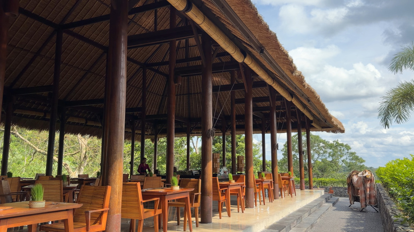 Plantation restaurant at Alila Ubud, an open-sided timber pavilion with tables and chairs overlooking the jungle