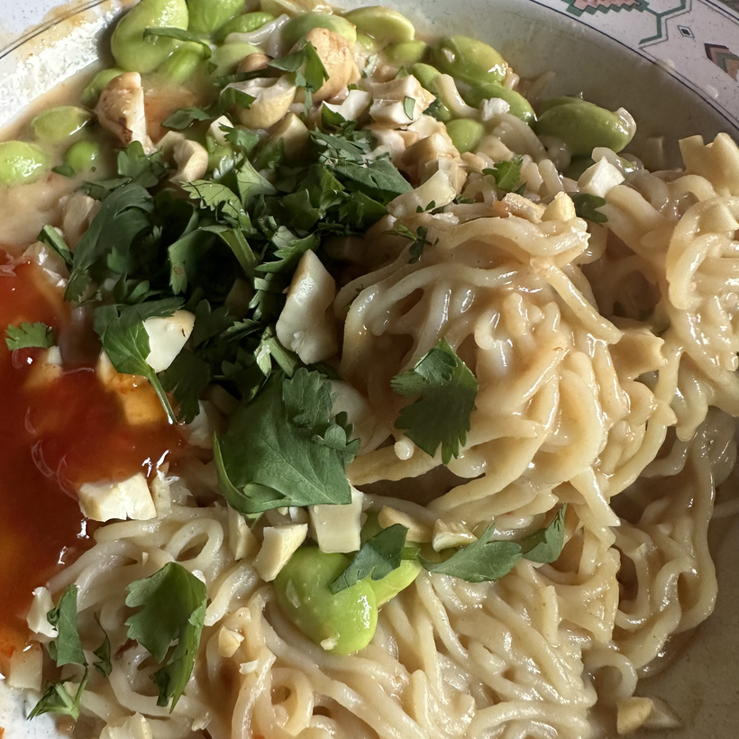Edamame ramen with cashews, cilantro & sweet chili sauce.