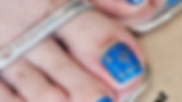 Blue pedicure with golden prints